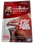 Hot balm packaging with a person applying it to their hand on a gray surface
